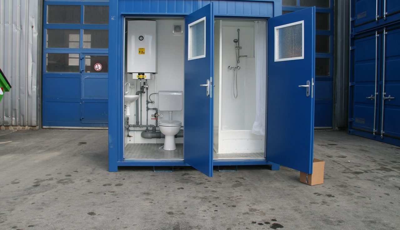 8ft welfare cabin with WC, basin and shower, doors open showing fitted interior