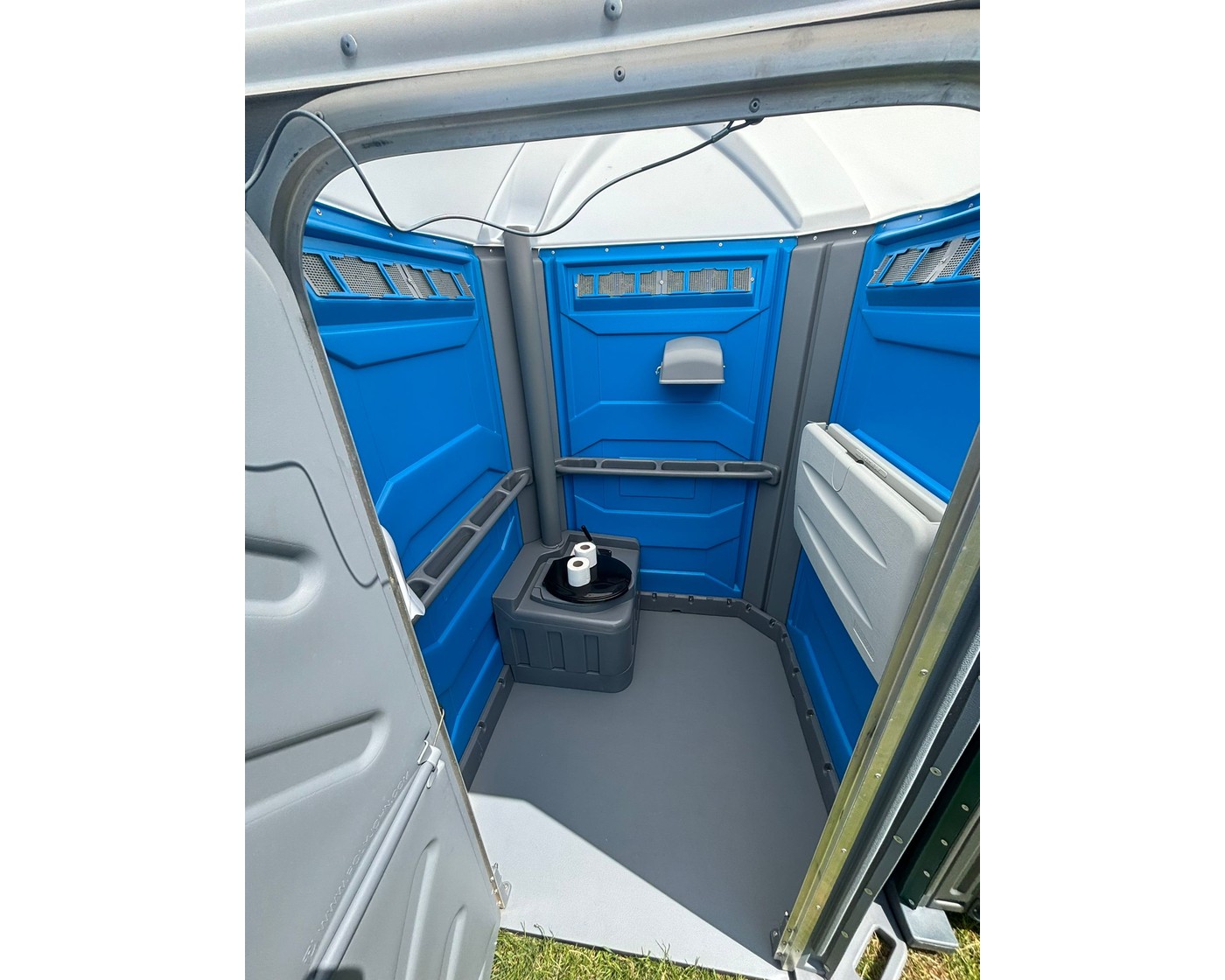 wheelchair accessible portable toilet interior with handrails and baby change table