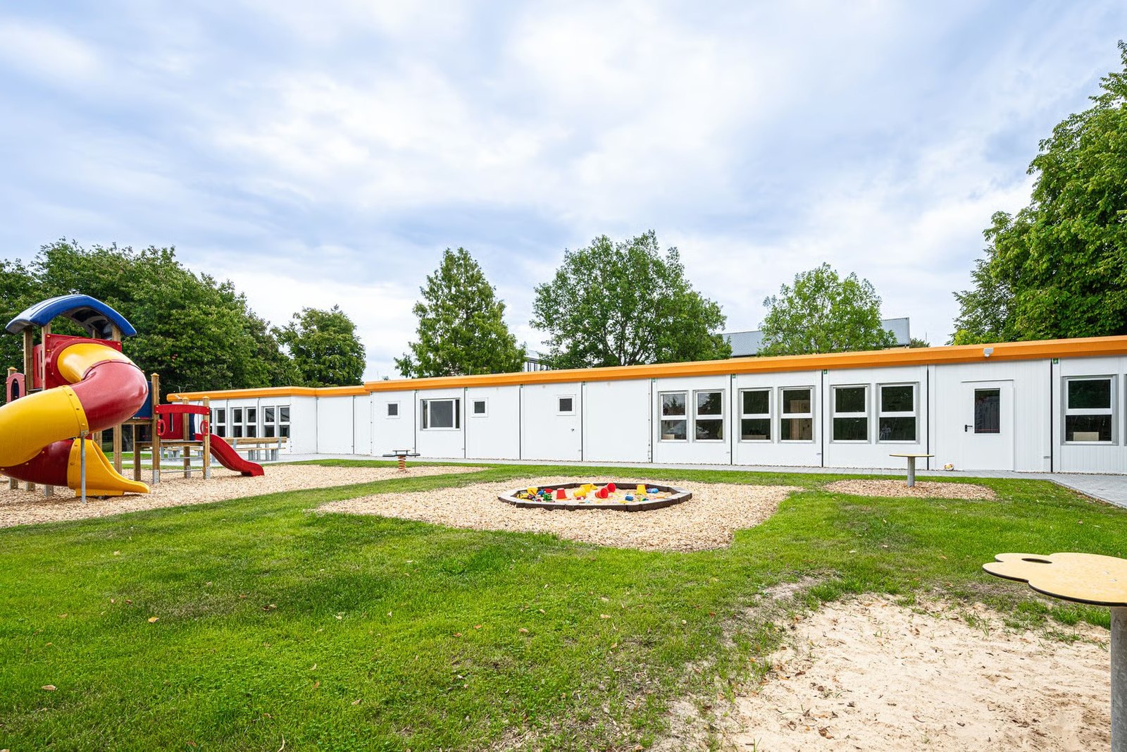 modular nursery building around a courtyard playground