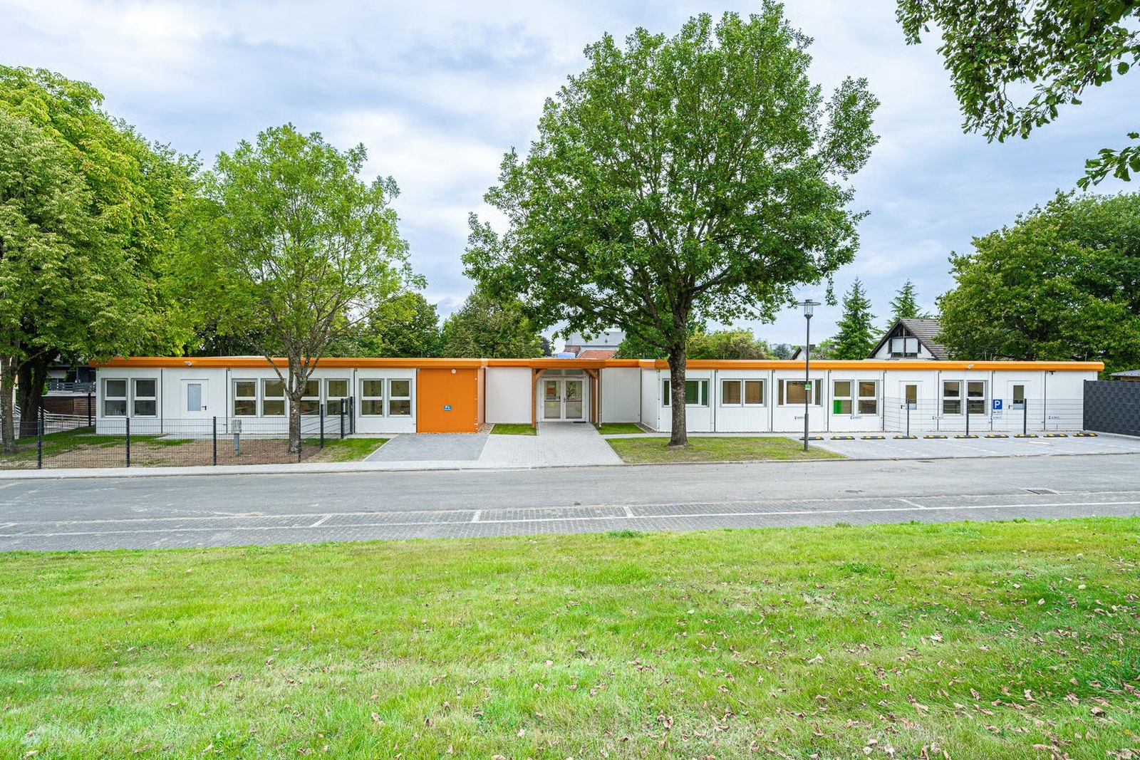 long modular school building with orange fascia band