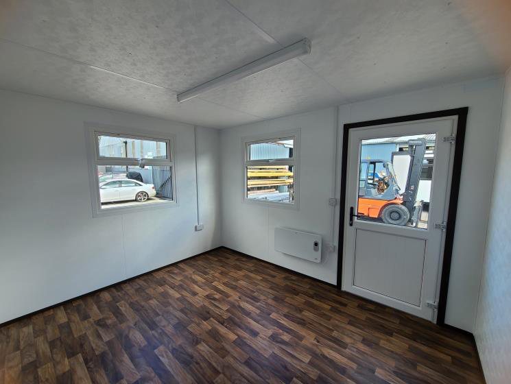 jackleg site office interior with wood effect floor and glazed door