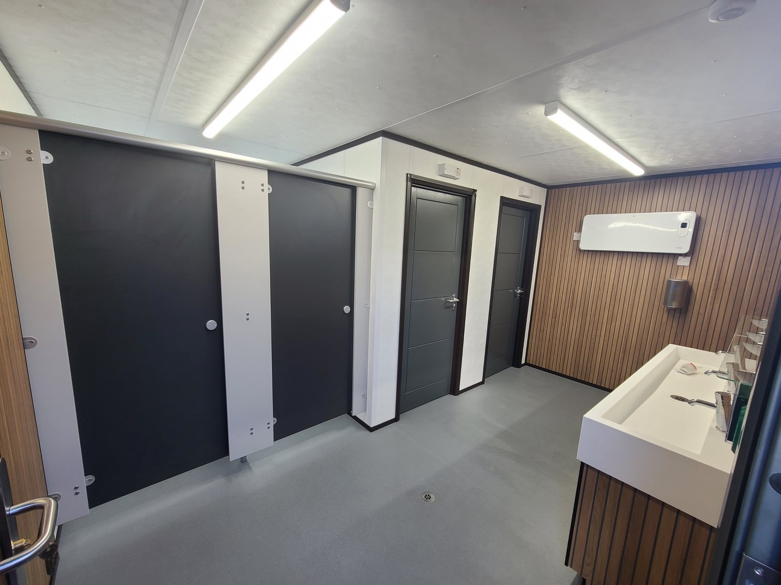 toilet cubicles and vanity unit inside a modular washroom building