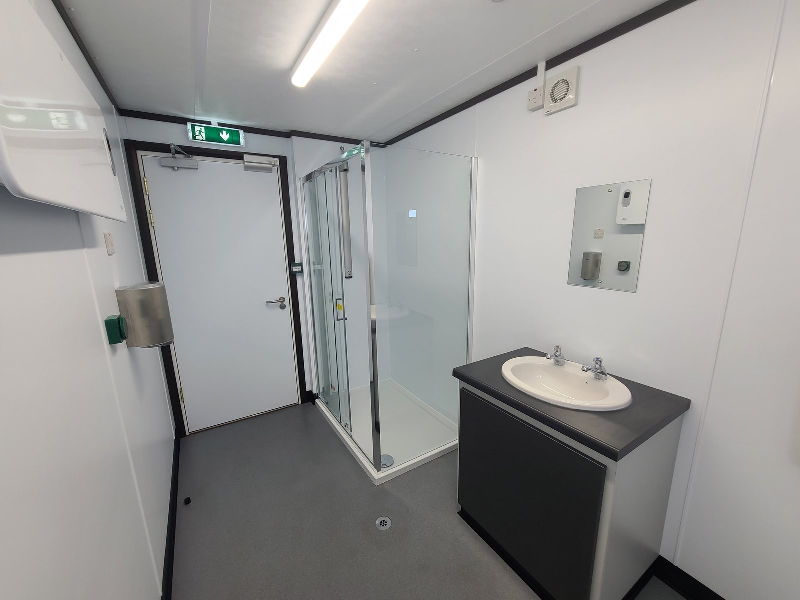 private en-suite washroom with shower, basin and vanity unit