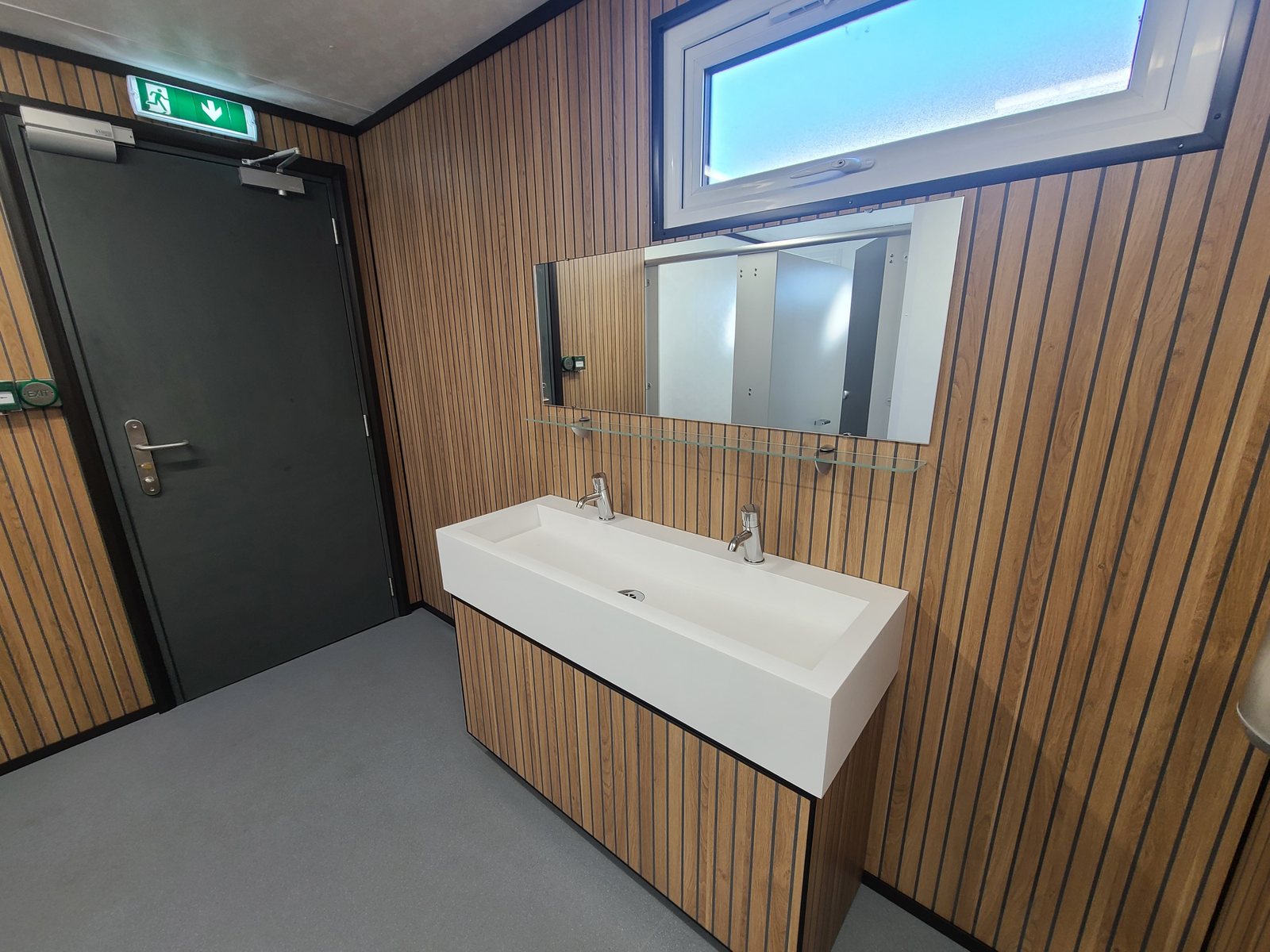 ladies washroom with twin basin vanity and wood panelled walls